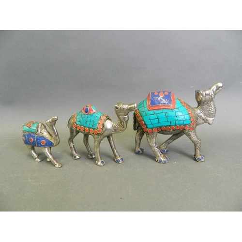 264 - A Middle Eastern mixed metal figure group of a caravan of camels with colourful inset composite deco... 