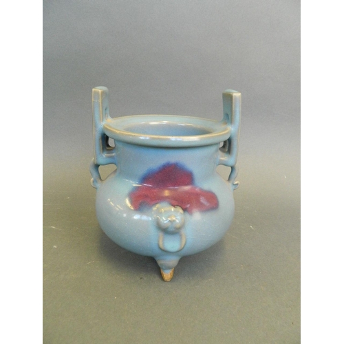 270 - A Chinese blue ground Jun ware twin handled censer with flambé glaze decoration, on tripod feet, 6