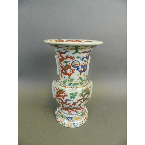 271 - A Chinese Wucai enamelled Gu shaped porcelain vase decorated with dragons chasing the flaming pearl,... 