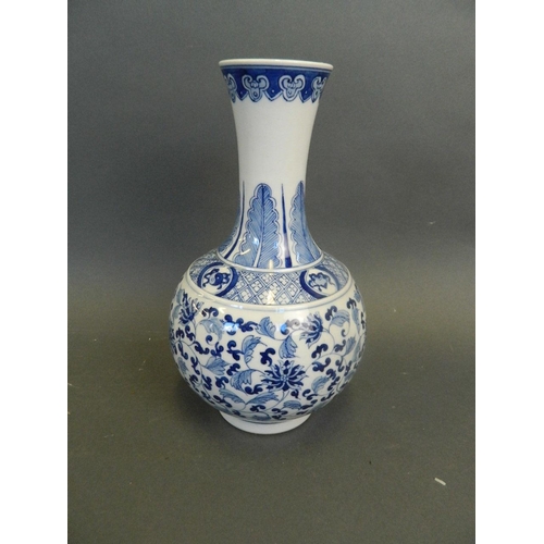 275 - A Chinese blue and white porcelain bottle vase with a flared rim and scrolling lotus flower decorati... 