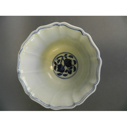 283 - A Chinese Ming style blue and white porcelain petal shaped bowl with painted decoration of dragons a... 