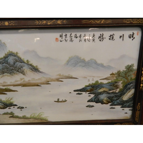 284 - A Chinese famille verte enamelled porcelain panel depicting an extensive landscape with riverside dw... 