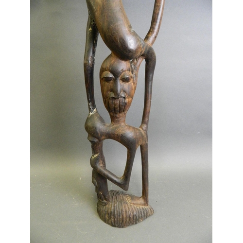 288 - An African hardwood abstract carving of a figure, 28