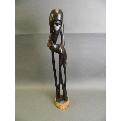 292 - An African ebonised hardwood abstract carving of a figure, 24½