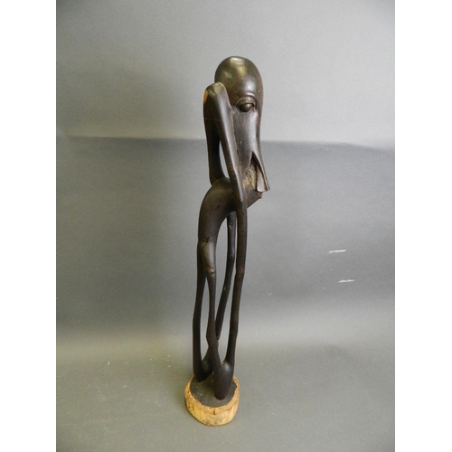 292 - An African ebonised hardwood abstract carving of a figure, 24½