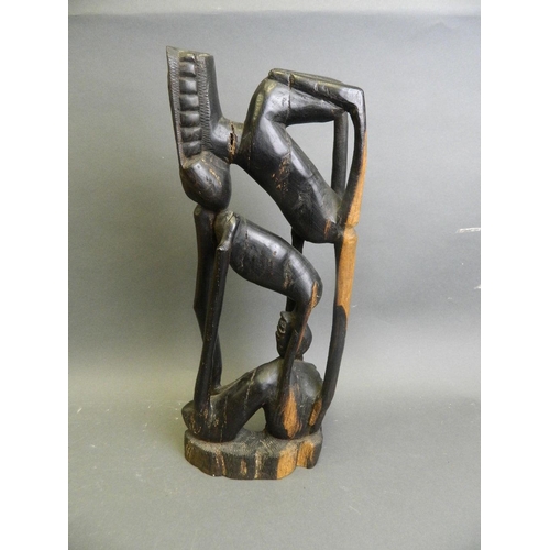 293 - An African hardwood abstract carving of a figure, 16½