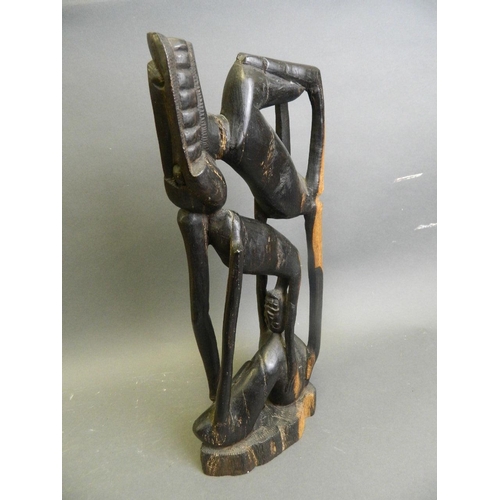 293 - An African hardwood abstract carving of a figure, 16½