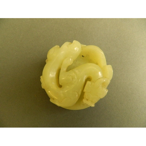 30 - A Chinese green jade circular seal with carved dragon decoration, 2½