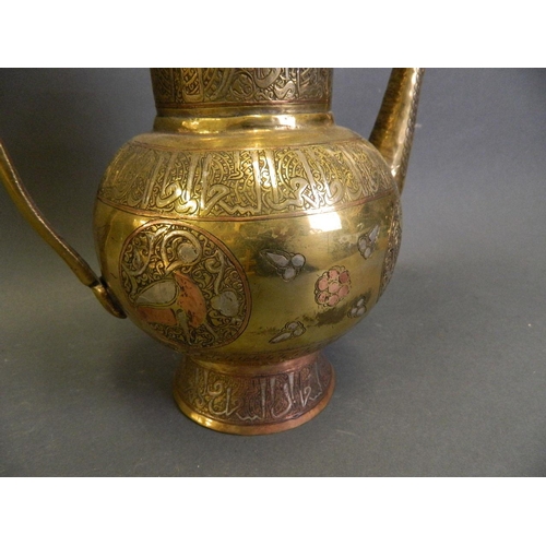 50F - An Islamic polished brass water pot with silver and copper inlaid decoration, 10½