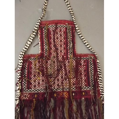 50M - An Uzbek red ground bag with all over medallion decoration, 18