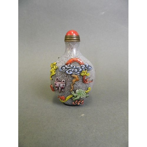 55 - A Chinese glass snuff bottle with carved and enamelled decoration of auspicious animals and items, 3... 