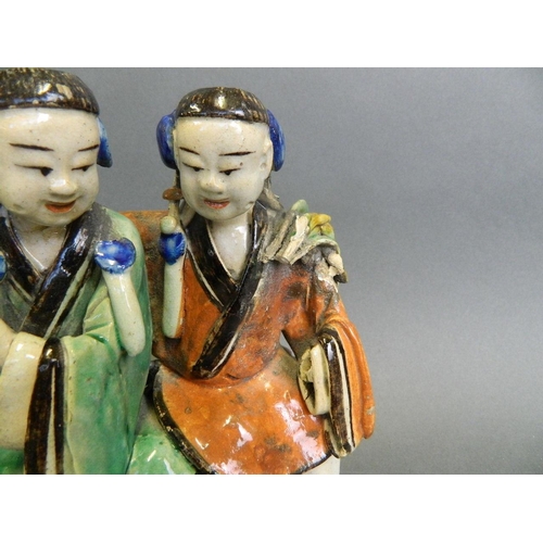 57 - An antique Chinese stoneware figure painted in bright enamels of a seated couple , 7