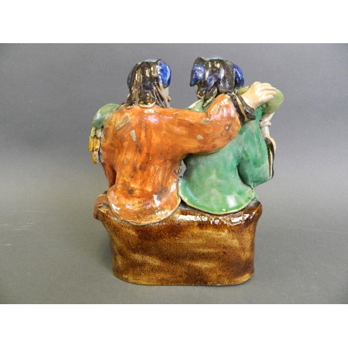 57 - An antique Chinese stoneware figure painted in bright enamels of a seated couple , 7