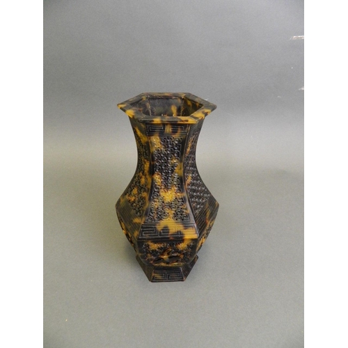 63 - A Chinese carved and pierced faux tortoiseshell hexagonal vase decorated with a stork in flight, eng... 