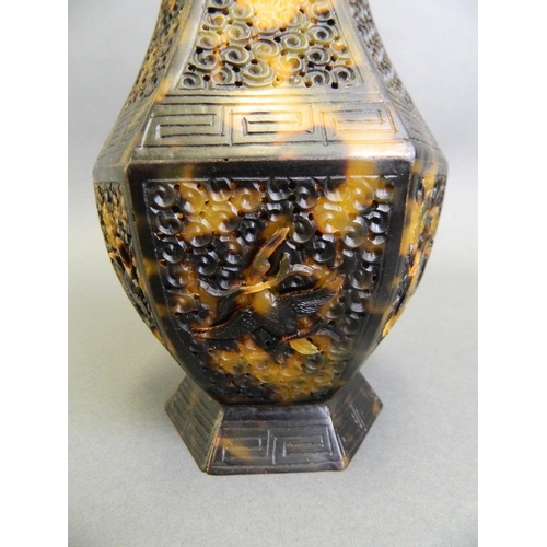 63 - A Chinese carved and pierced faux tortoiseshell hexagonal vase decorated with a stork in flight, eng... 