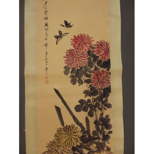 64 - A Chinese watercolour scroll depicting butterflies amongst dahlias, 18