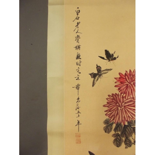 64 - A Chinese watercolour scroll depicting butterflies amongst dahlias, 18