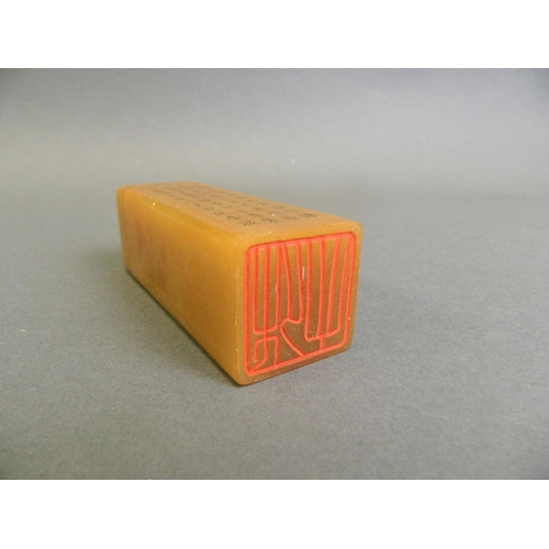 70 - A Chinese amber soapstone seal decorated with character inscription, 1½