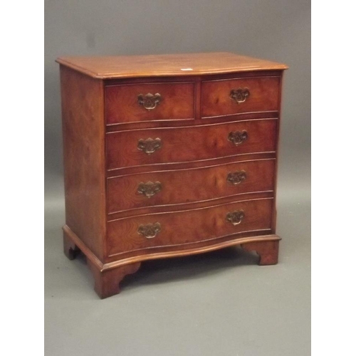 855 - A Georgian style elm veneered serpentine fronted chest of two over three drawers, raised on bracket ... 