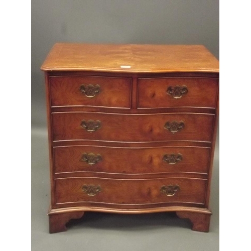 855 - A Georgian style elm veneered serpentine fronted chest of two over three drawers, raised on bracket ... 