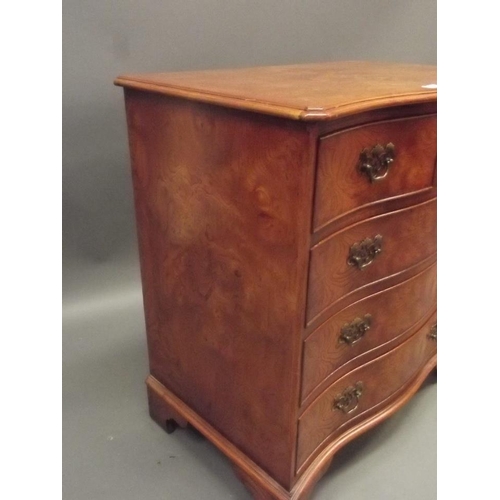 855 - A Georgian style elm veneered serpentine fronted chest of two over three drawers, raised on bracket ... 