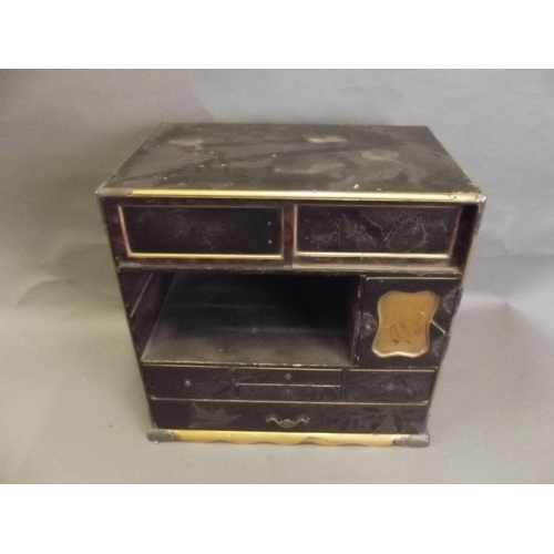 856 - A Japanese lacquered table top cabinet with multiple drawers decorated with gilt on a black ground, ... 