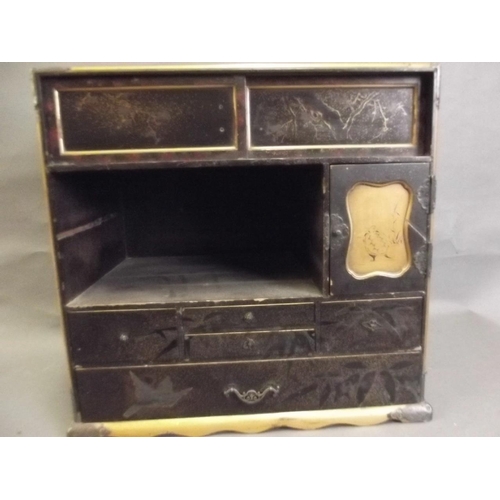 856 - A Japanese lacquered table top cabinet with multiple drawers decorated with gilt on a black ground, ... 