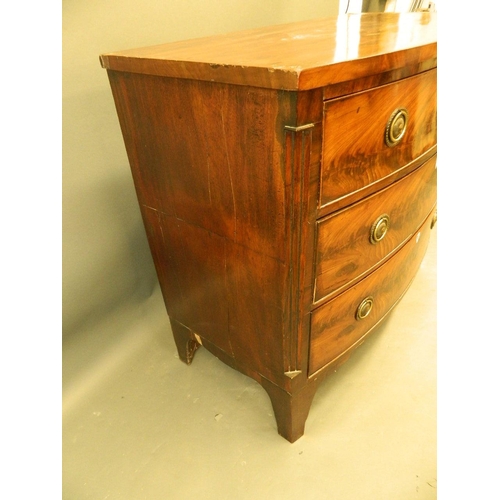 858 - A C19th figured mahogany bow fronted chest of three graduated drawers, raised on swept supports, 43