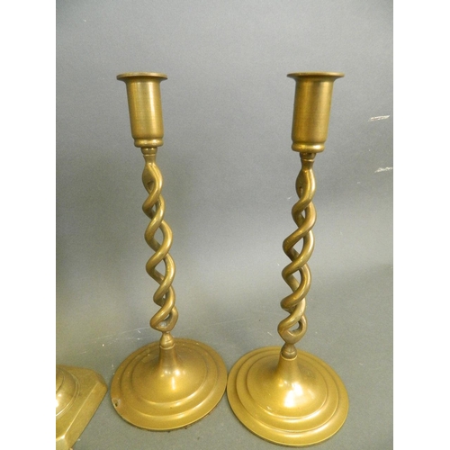 93 - A pair of C19th brass ejector candlesticks, together with a pair of brass open barley twist candlest... 