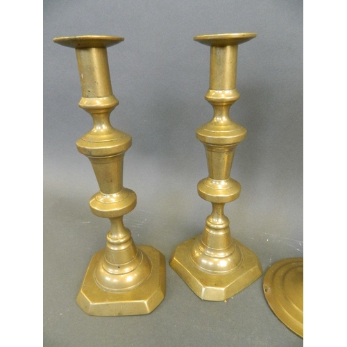 93 - A pair of C19th brass ejector candlesticks, together with a pair of brass open barley twist candlest... 