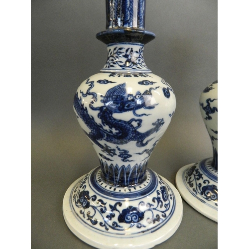 95 - A pair of Chinese blue and white porcelain vases of unusual form decorated with a dragon chasing the... 