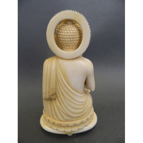 100 - A finely carved antique ivory figure of Buddha seated in meditation on a lotus throne, 5½