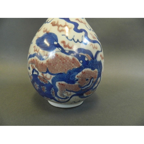 106 - A Chinese blue, white and red porcelain vase with twin kylin decoration, 9