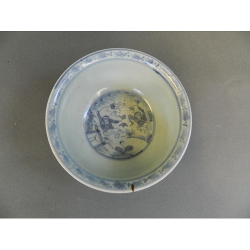 114 - A Chinese blue and white porcelain rice bowl with painted decoration of boys playing in a garden, 5½... 