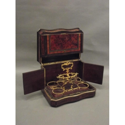 132 - A C19th French amboyna tantalus with ebony and rosewood inlaid decoration and brass mounts, opening ... 