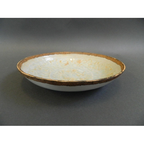 135 - A Chinese Song style celadon glazed trinket dish with relief floral decoration, 7