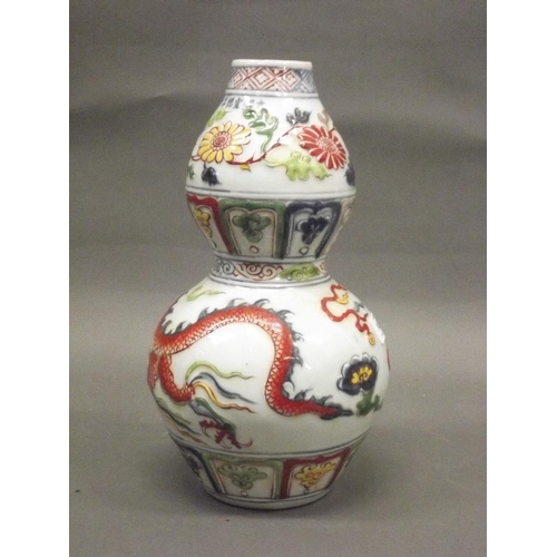 146 - A Chinese earthenware dragon vase with raised enamel decoration, 13