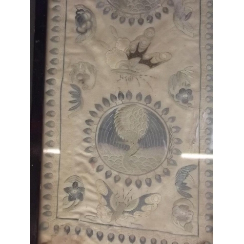 150R - An Oriental embroidered silk border decorated with roundels depicting exotic birds, 5½