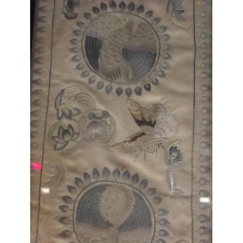 150R - An Oriental embroidered silk border decorated with roundels depicting exotic birds, 5½