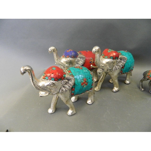 150T - A collection of Middle Eastern mixed metal figure groups, comprising a caravan of camels, and elepha... 