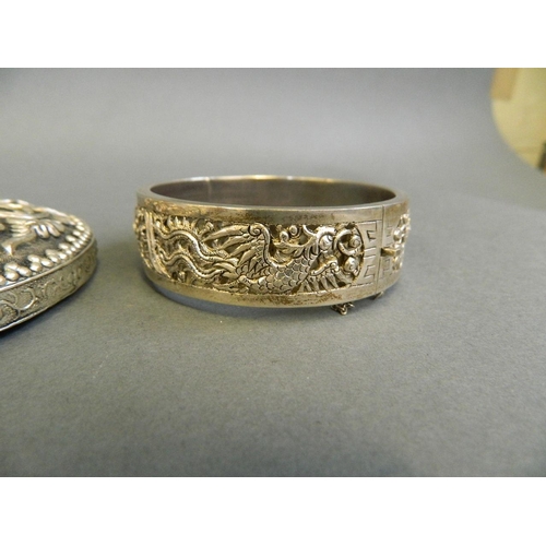 170 - A Chinese white metal bangle with pierced phoenix decoration, together with a mixed metal mounted ha... 