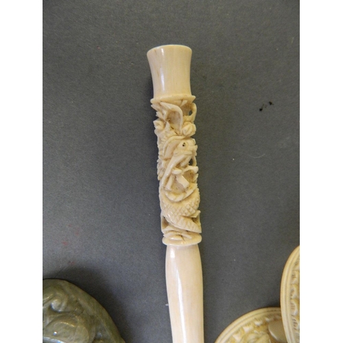 179 - A Cantonese ivory cheroot holder with carved dragon decoration, together with three Cantonese ivory ... 