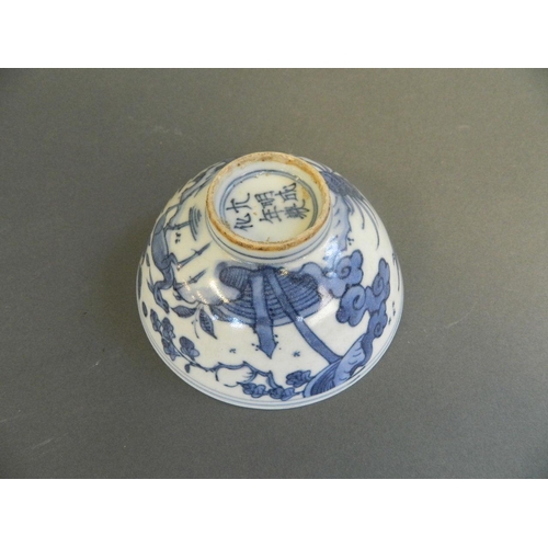 207 - A Chinese blue and white porcelain rice bowl with painted decoration of birds and deer in a rural la... 