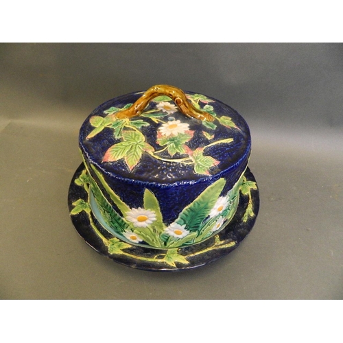 209 - A Majolica cheese dish by George Jones, decorated with flowers and leaves on a blue ground, 8