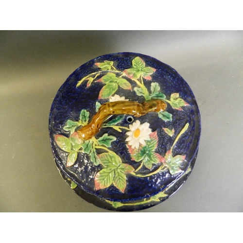 209 - A Majolica cheese dish by George Jones, decorated with flowers and leaves on a blue ground, 8