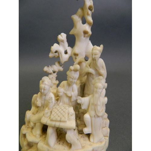 210 - A fine C19th Cantonese ivory figure group of four immortals under a cypress tree, with engraved flor... 