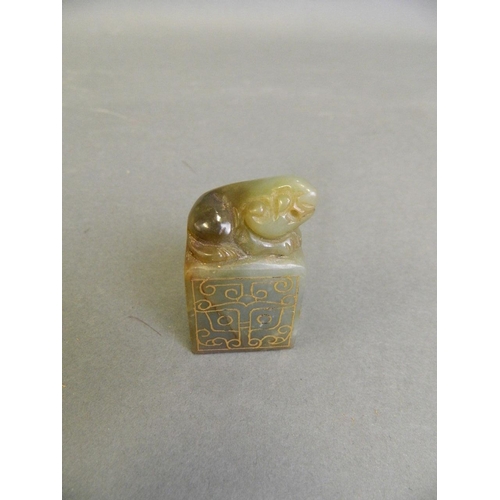 212 - A Chinese mottled green jade seal with carved Fo dog knop and inlaid gilt stylised decoration, 2