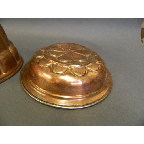 226 - Two early C20th copper jelly moulds, together with another brass mould, largest 10