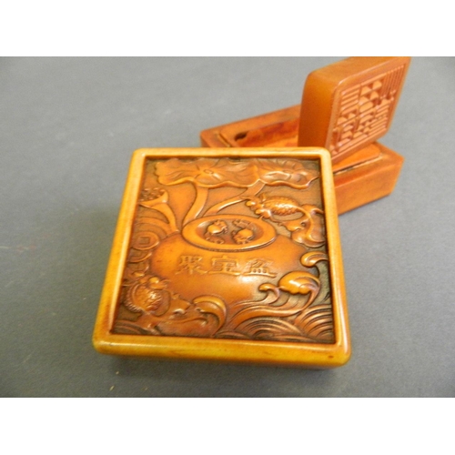 232 - A Chinese soapstone box with engraved goldfish bowl decoration to lid and amber soapstone seal withi... 