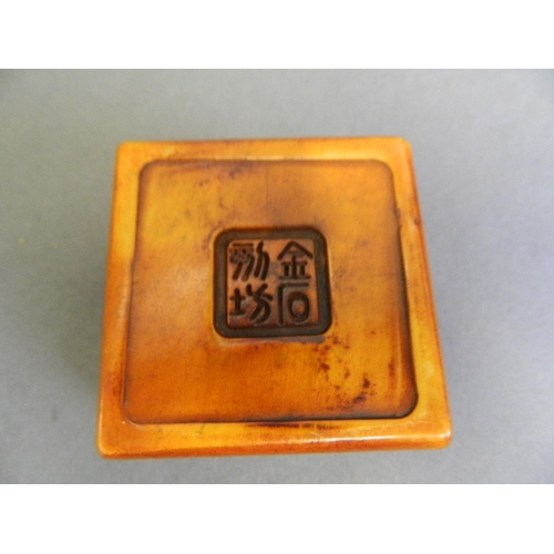 232 - A Chinese soapstone box with engraved goldfish bowl decoration to lid and amber soapstone seal withi... 